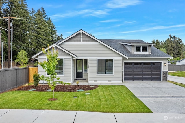 view of front of home with a garage and a front lawn