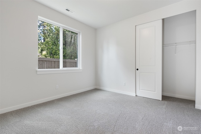 unfurnished bedroom featuring carpet and a closet