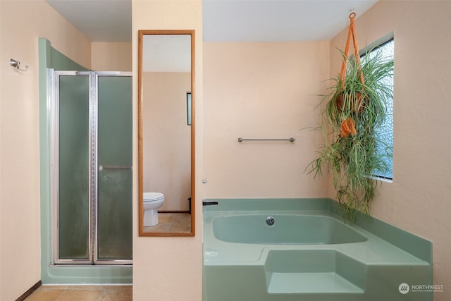 full bath with toilet, tile patterned floors, a bath, and a stall shower