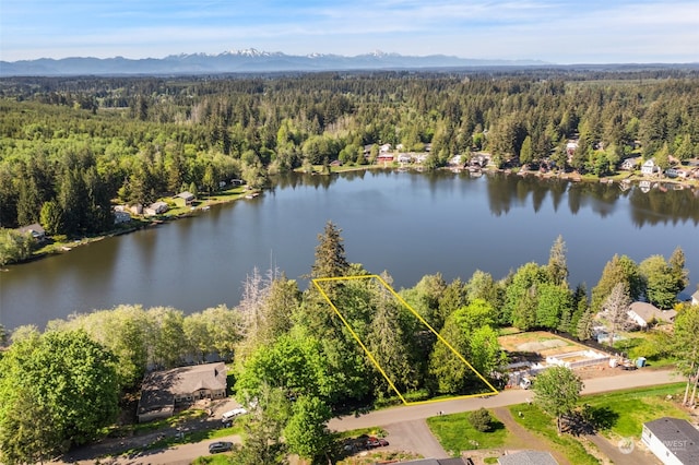 aerial view featuring a view of trees and a water view