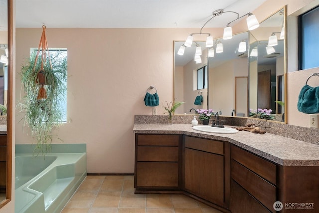 bathroom featuring a bath, tile patterned floors, and vanity