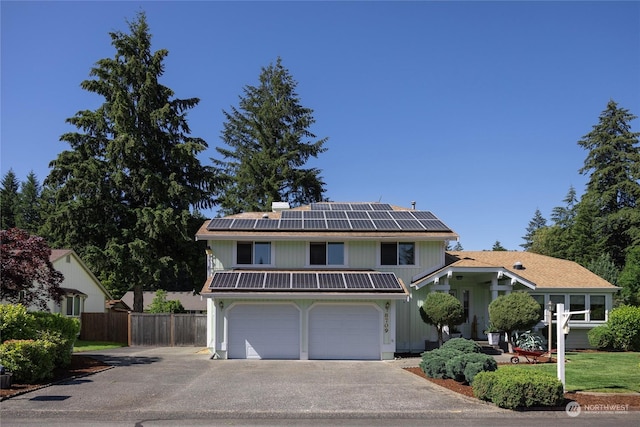 view of front of house with solar panels and a garage