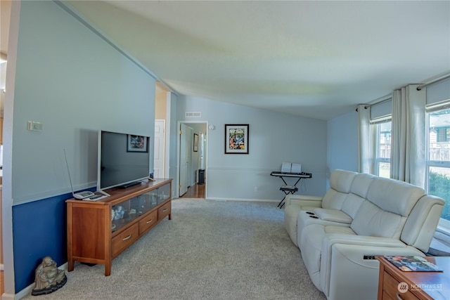 living room with light colored carpet and lofted ceiling