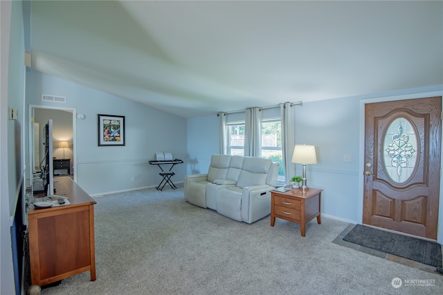 living room featuring light colored carpet and vaulted ceiling