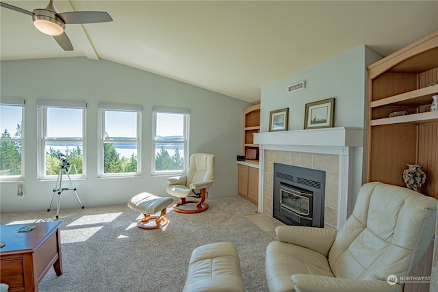 living room with ceiling fan, lofted ceiling with beams, light carpet, and a wealth of natural light