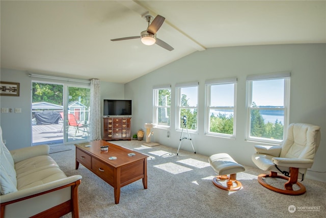 carpeted living room featuring ceiling fan and lofted ceiling