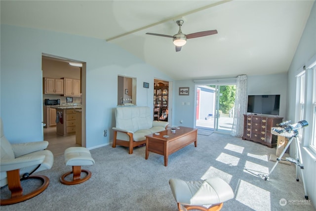 carpeted living room with vaulted ceiling and ceiling fan