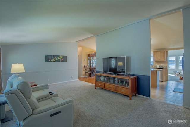 carpeted living room featuring vaulted ceiling