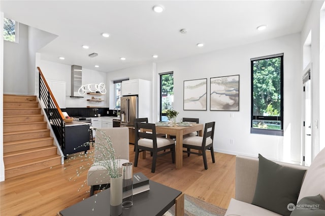 dining space featuring plenty of natural light, sink, and light hardwood / wood-style flooring