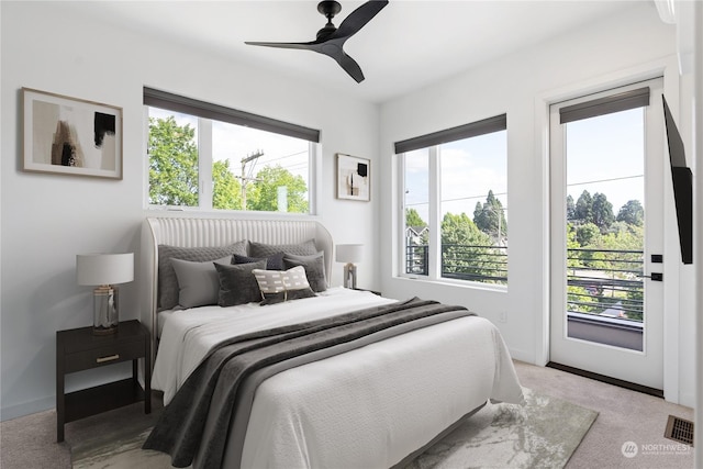 carpeted bedroom featuring ceiling fan and access to outside