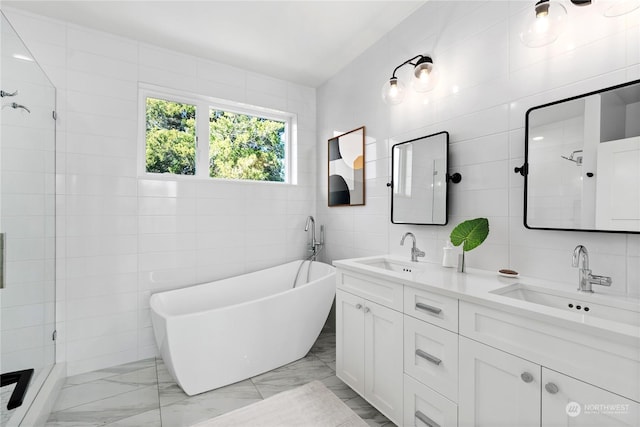 bathroom featuring vanity, independent shower and bath, and tile walls