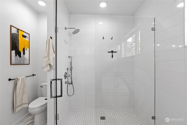 bathroom featuring walk in shower and toilet