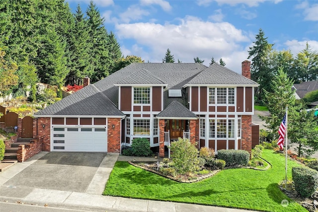 tudor-style house featuring brick siding, a chimney, concrete driveway, a garage, and a front lawn