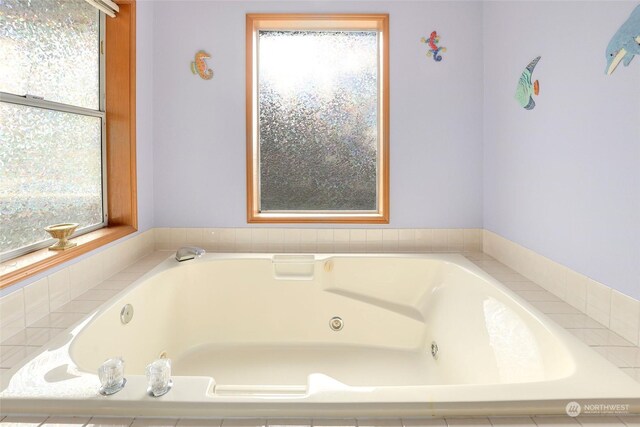 bathroom featuring a tub with jets and plenty of natural light