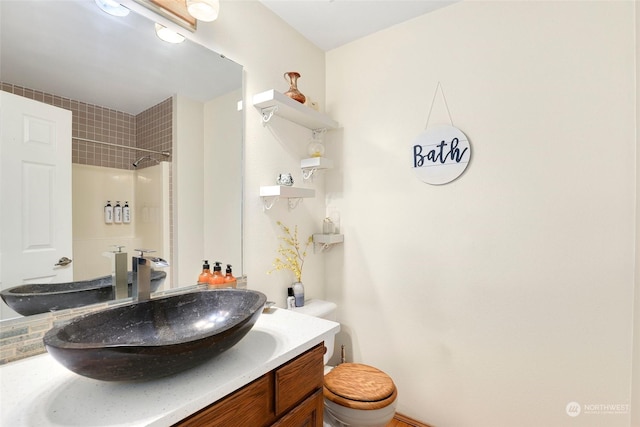 full bath featuring vanity, toilet, and walk in shower