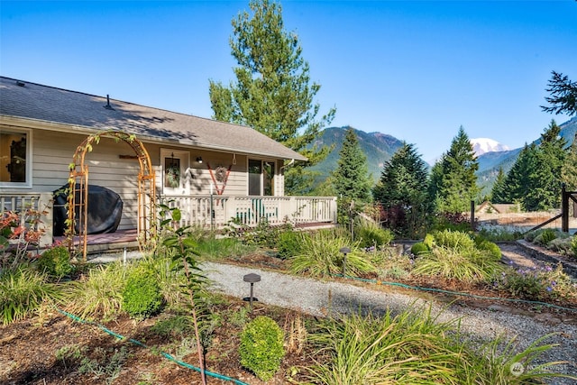 view of front facade with a deck with mountain view