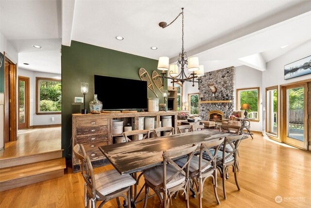 132 Hellem Dr, Packwood, WA 98361 - dining area with light wood-style floors, a stone fireplace, plenty of natural light, recessed lighting, and a chandelier