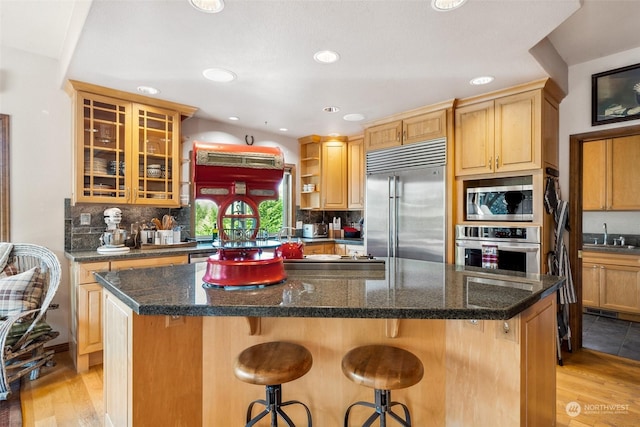 132 Hellem Dr, Packwood, WA 98361 - kitchen featuring built in appliances, light wood-style floors, a kitchen island, a kitchen breakfast bar, and recessed lighting