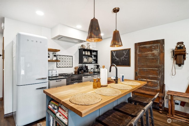 132 Hellem Dr, Packwood, WA 98361 - kitchen featuring open shelves, freestanding refrigerator, butcher block counters, black gas range oven, and dark wood-style flooring
