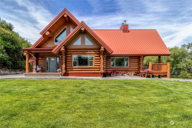 rear view of house with a porch and a yard