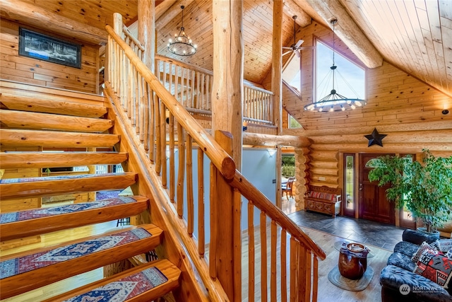 stairs featuring an inviting chandelier, wood ceiling, high vaulted ceiling, and beamed ceiling