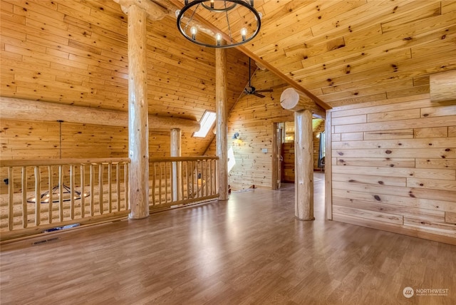 additional living space featuring wood ceiling, hardwood / wood-style flooring, ceiling fan, high vaulted ceiling, and wood walls