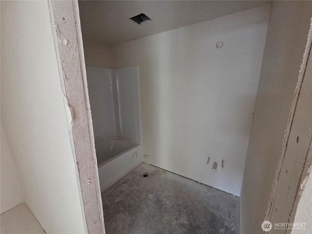 full bath featuring concrete floors and shower / washtub combination