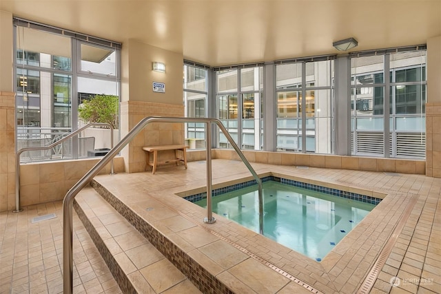 view of swimming pool with an indoor in ground hot tub