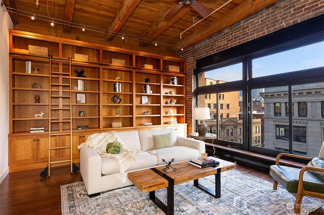 sitting room with beam ceiling, rail lighting, dark wood-type flooring, and wooden ceiling