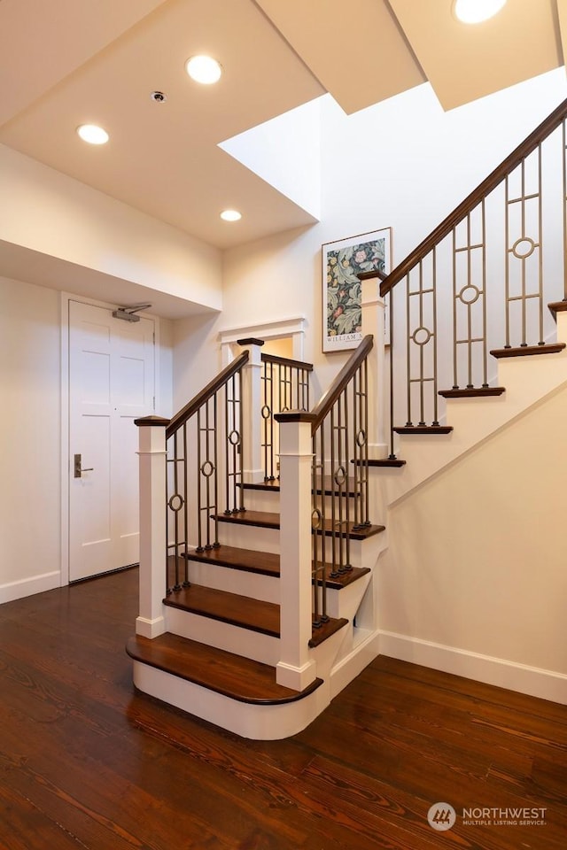 staircase with wood-type flooring