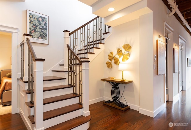 stairs with hardwood / wood-style flooring