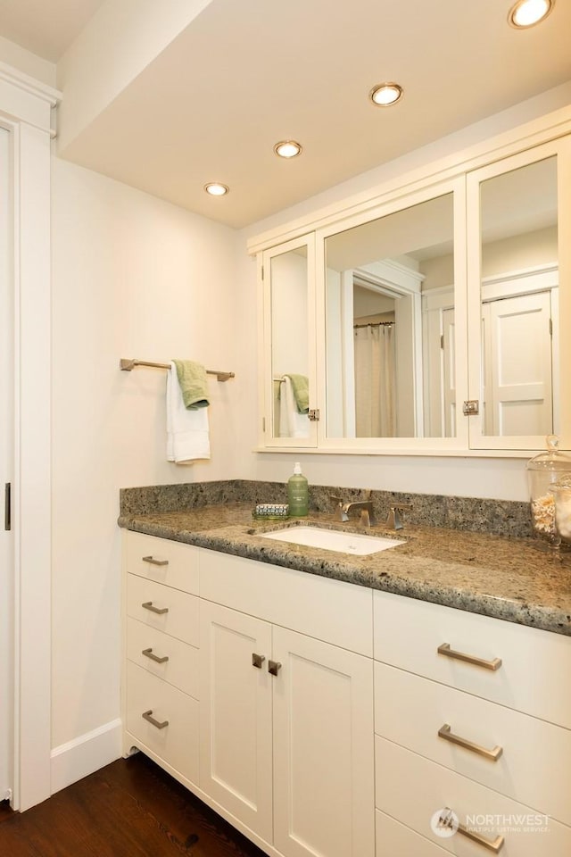 bathroom featuring vanity and hardwood / wood-style flooring