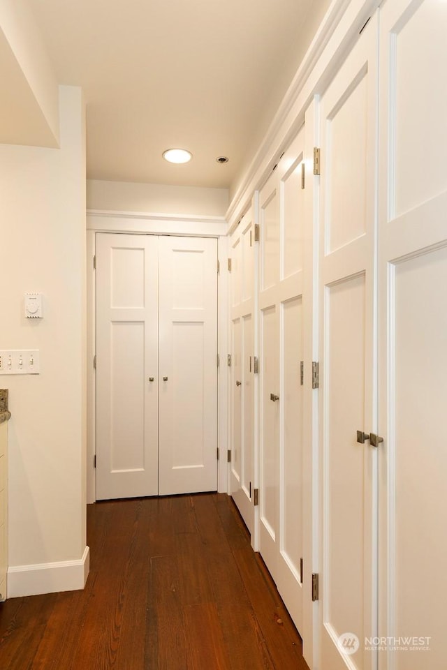 corridor featuring dark hardwood / wood-style flooring