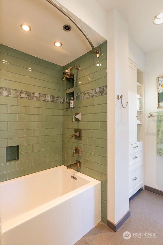 bathroom with tile patterned floors and tiled shower / bath