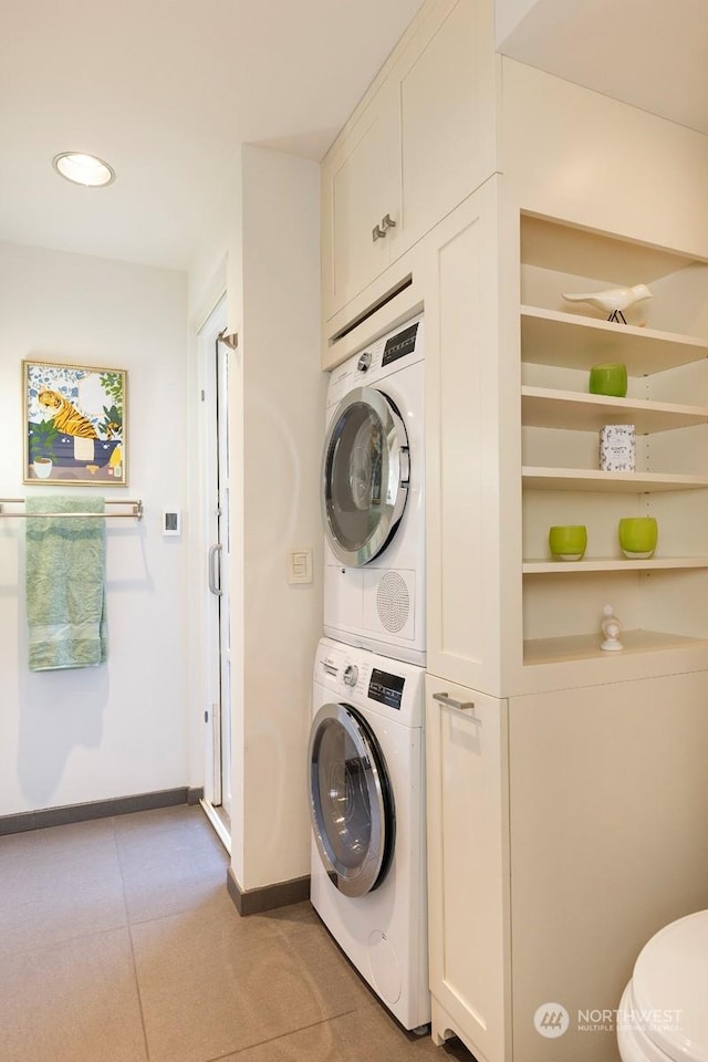 washroom with stacked washer / drying machine