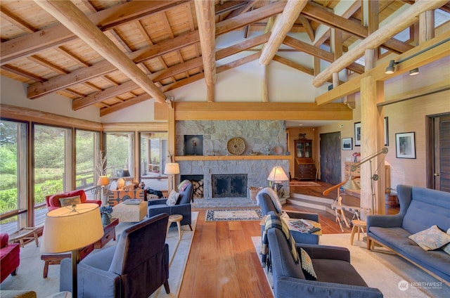 living room with hardwood / wood-style floors, beam ceiling, wooden ceiling, and a fireplace