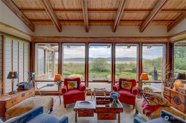 sunroom featuring vaulted ceiling with beams, a mountain view, and wooden ceiling