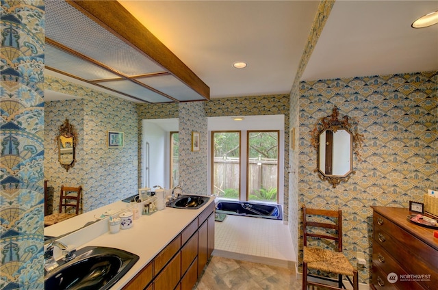 bathroom with vanity and a bath