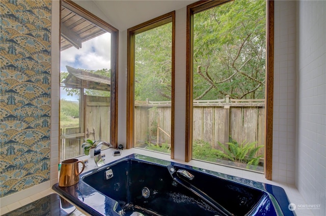 bathroom with vaulted ceiling and a bathtub