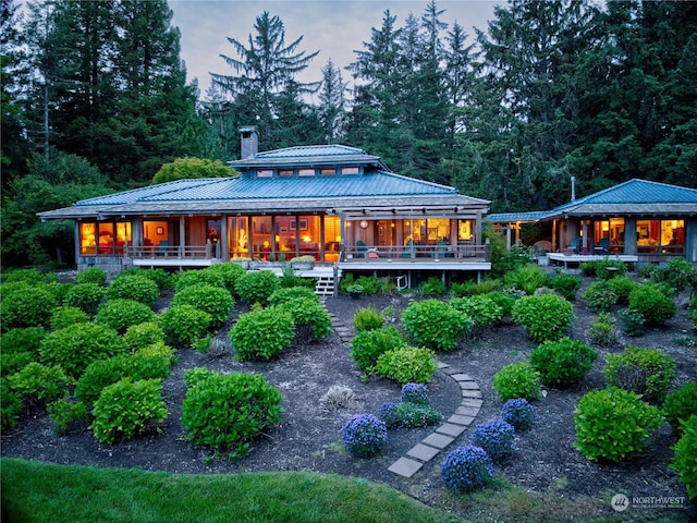 view of back house at dusk