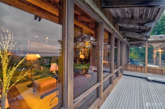 sunroom / solarium featuring beam ceiling and wooden ceiling