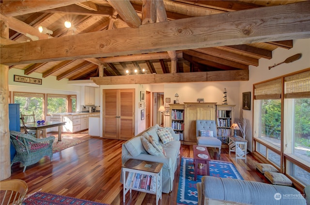 living room with beam ceiling, wood-type flooring, and a wealth of natural light