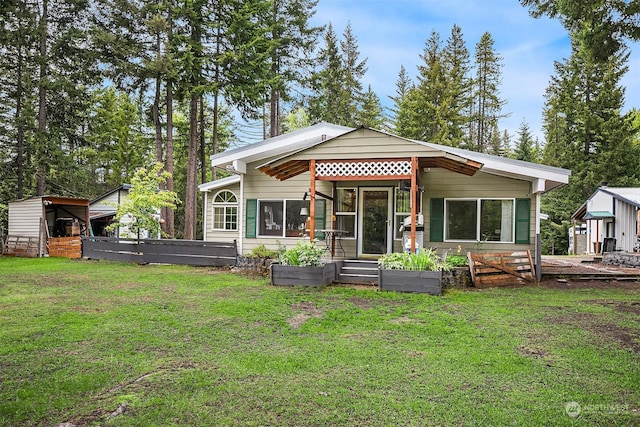 81 Hawthorn Ln, Easton, WA 98925 - rear view of house with a yard and a vegetable garden