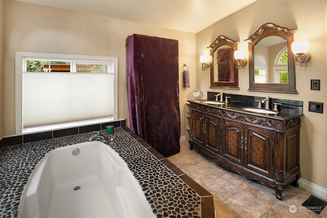 81 Hawthorn Ln, Easton, WA 98925 - bathroom featuring plenty of natural light, double vanity, a garden tub, and tile patterned floors