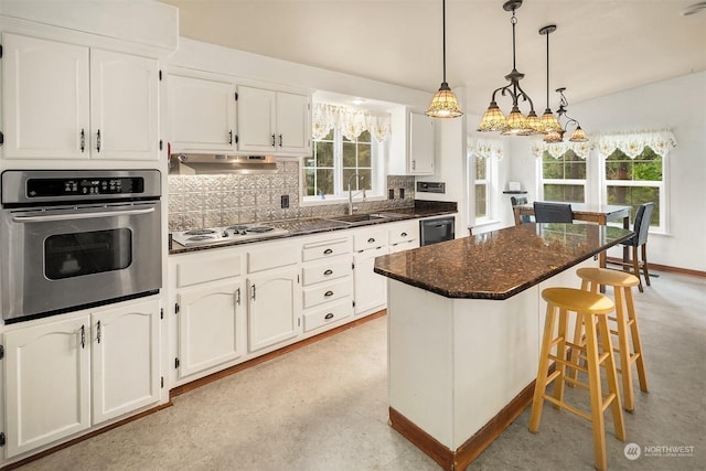 81 Hawthorn Ln, Easton, WA 98925 - kitchen with oven, electric cooktop, a kitchen bar, dishwasher, and decorative backsplash