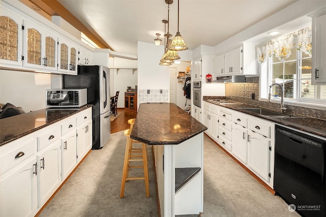 81 Hawthorn Ln, Easton, WA 98925 - kitchen with appliances with stainless steel finishes, tasteful backsplash, a kitchen island, white cabinets, and glass insert cabinets