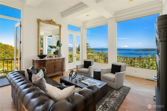 sunroom / solarium with beamed ceiling, french doors, a water view, and coffered ceiling