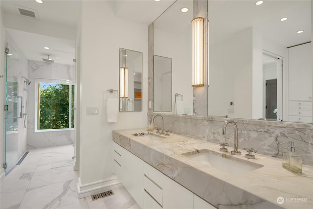 bathroom featuring vanity and a shower with shower door