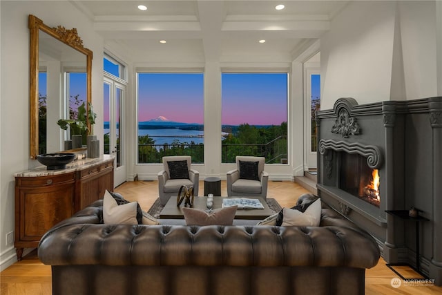 living room with beamed ceiling, a water view, light parquet floors, and coffered ceiling