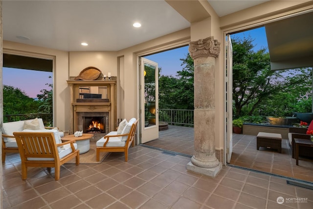 entryway with tile patterned floors and exterior fireplace